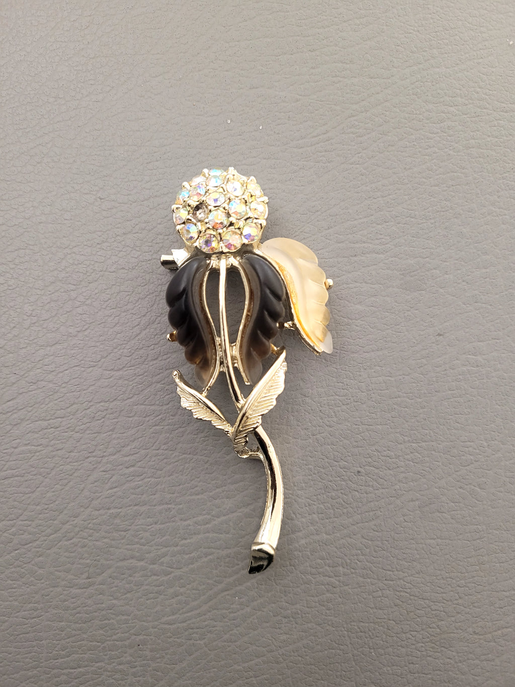 Vintage unsigned Lisner thermoset petals rhinestone flower brooch.
