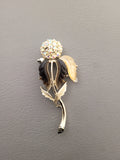 Vintage unsigned Lisner thermoset petals rhinestone flower brooch.
