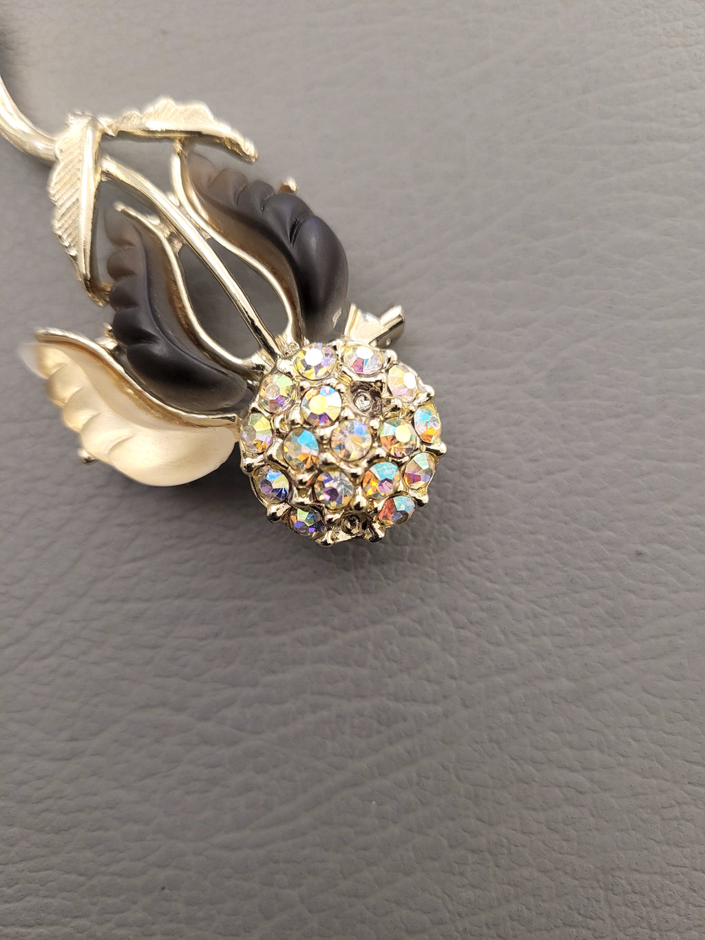 Vintage unsigned Lisner thermoset petals rhinestone flower brooch.