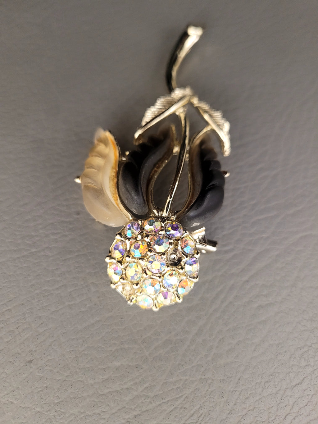Vintage unsigned Lisner thermoset petals rhinestone flower brooch.